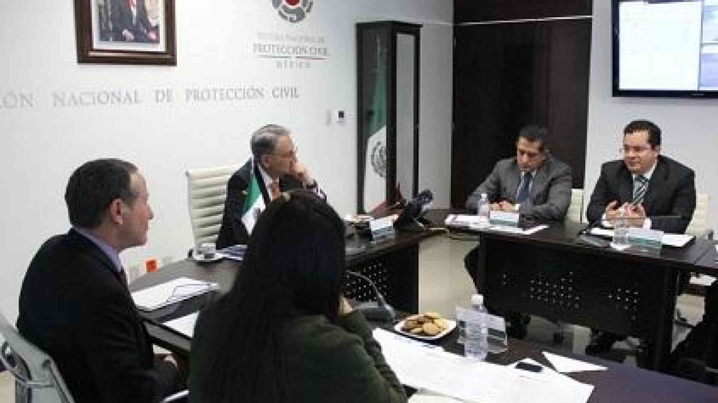 UNISDR chief Mr. Robert Glasser (left) meets with staff from Mexico's National Civil Protection System, including its head Mr. Luis Felipe Puente (centre left)