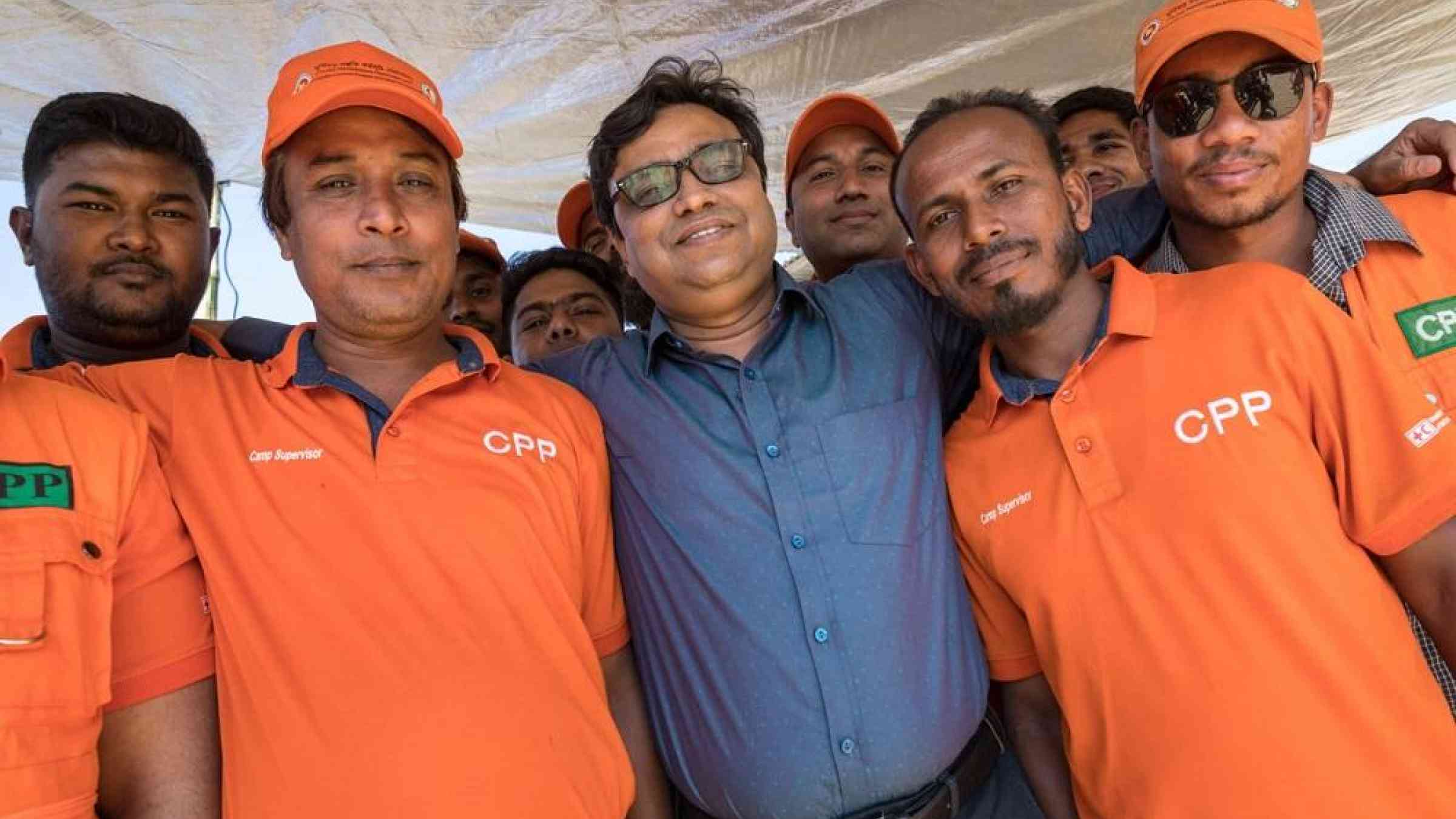 Bangladesh government Cyclone Preparedness Programme Director, Ahmadul Haque, sharing a light-hearted moment with volunteers in Cox's Bazar