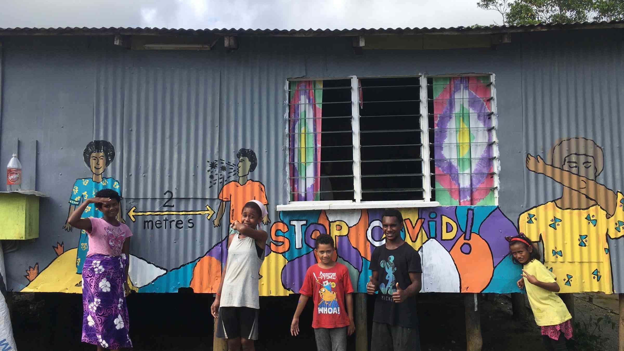 Youth and a COVID-19 awareness mural, Fiji