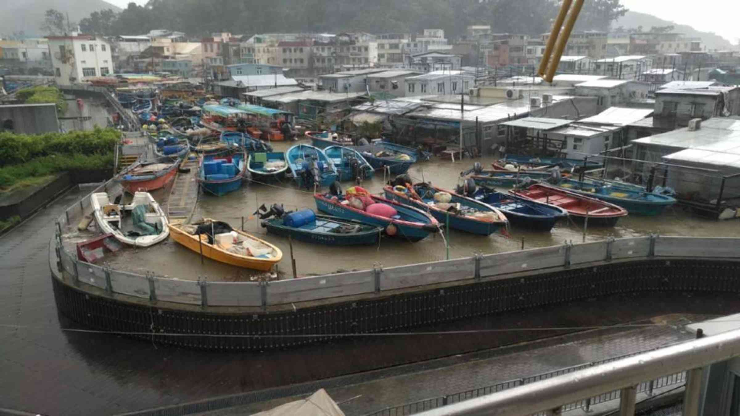 Caption: ‘Protection Zone’ consisting of concrete walls and demountable flood barriers at the low-lying fishing village of Tai O in Lantau Island, Hong Kong Special Administrative Region, China. 