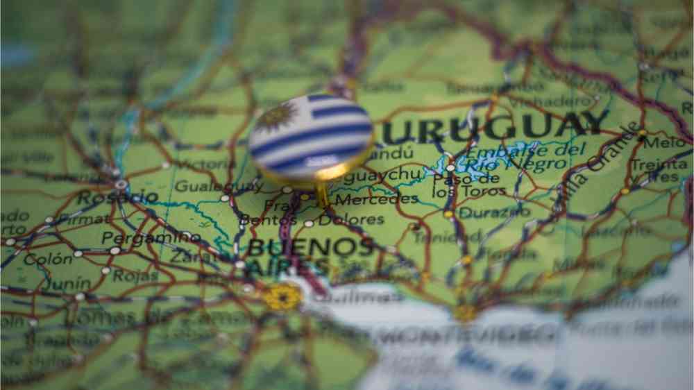 A pin with the flag of Uruguay pinned on a map.