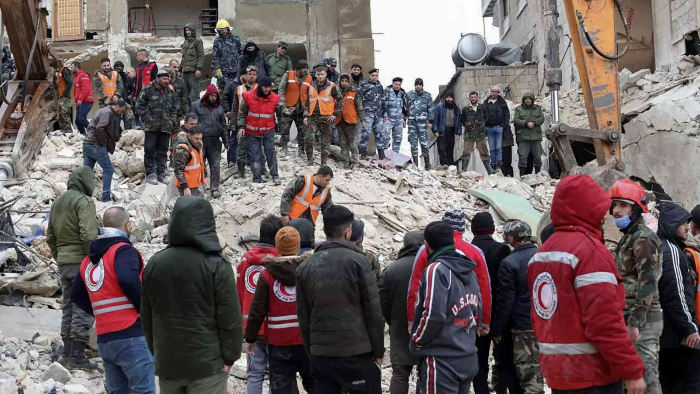 Rescuers search for survivors at the site of a collapsed building in Hama, Syria on 6 February 2023