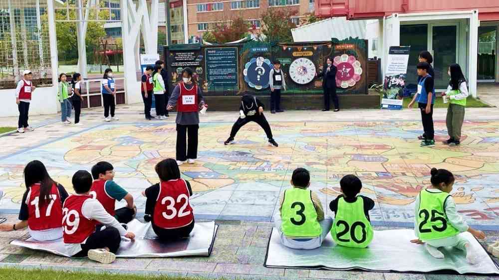 children learning DRR by playing on the life-size Riskland game in Hwaseong Republic of Korea