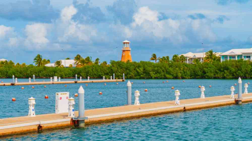 Empty pier in Varadero, Cuba and a lighthouse in the background.