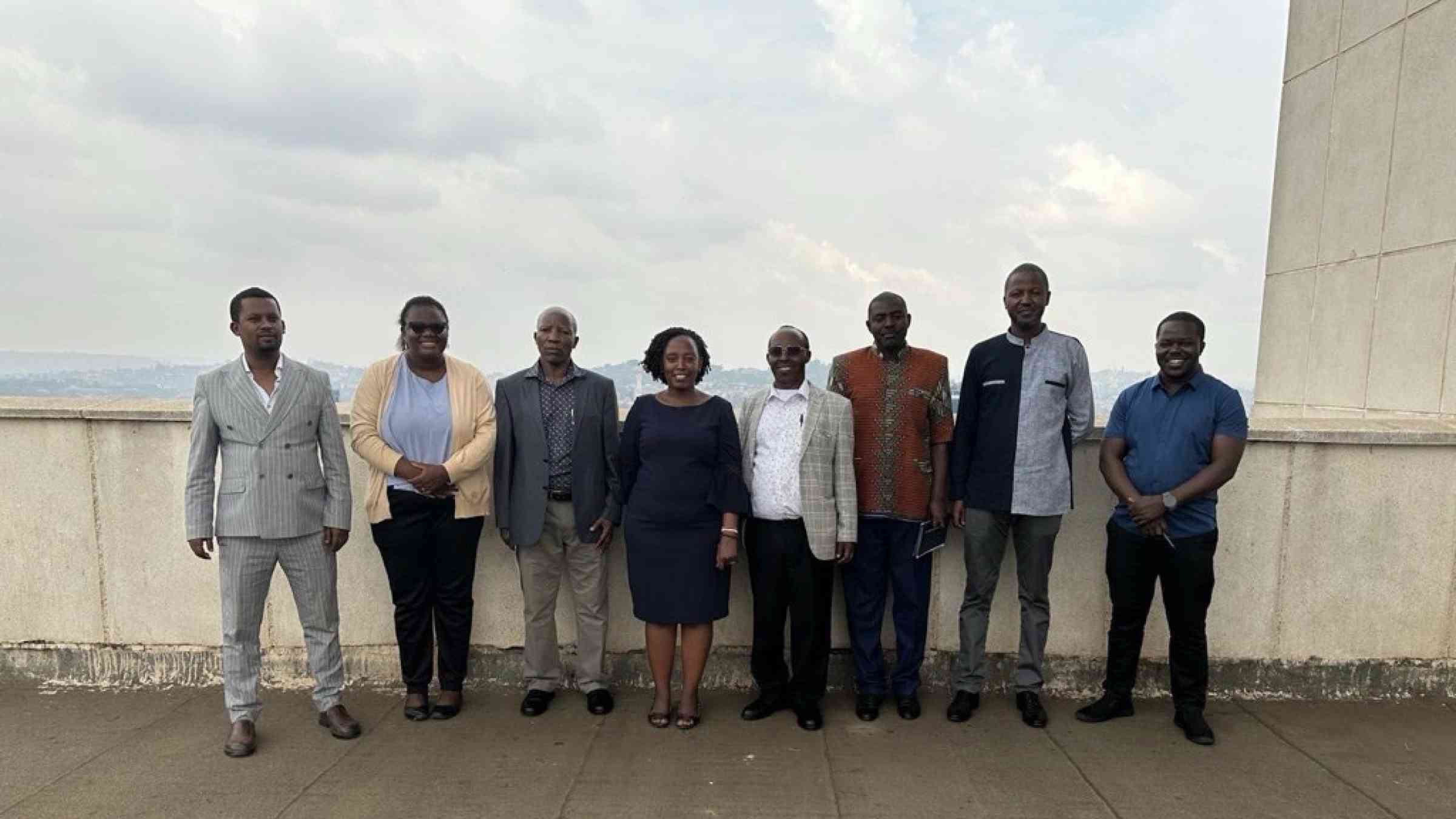 Eight participants from the Managing transboundary water risks in the Horn of Africa event stood together for a group photo, outdoors