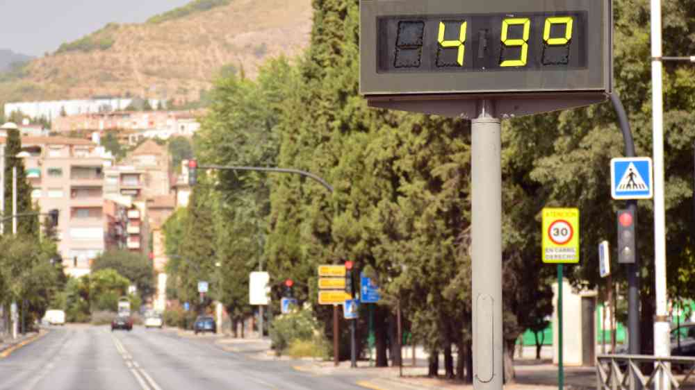 Street thermometer in summer marking 49 degrees celsius