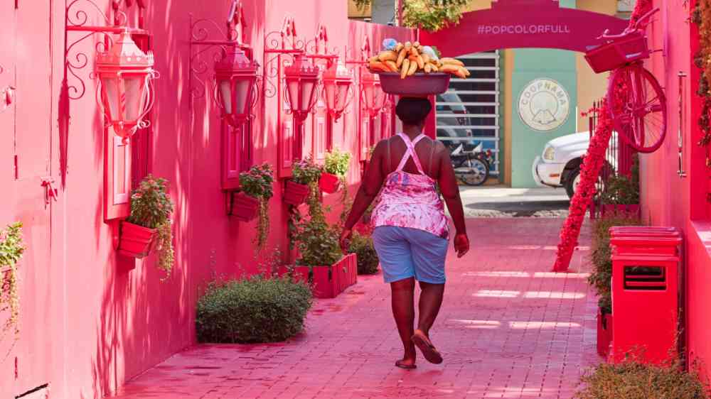 Woman carries a bowl of bananas on her head in Puerto Plata, Dominican Republic