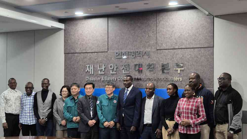Workshop participants pose for a formal group photo at headquarters