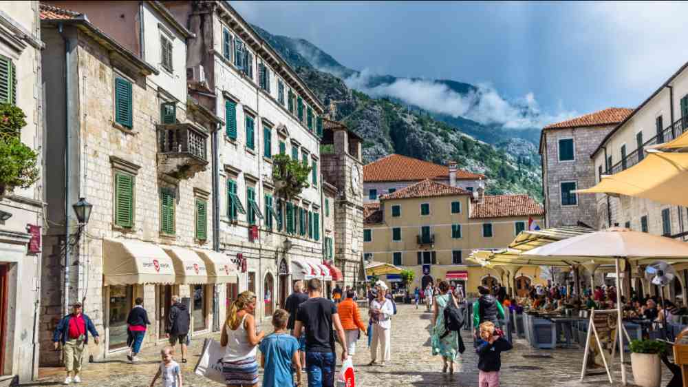 People walking on old town street at sunny day at June 18, 2014 in Kotor, Montenegro