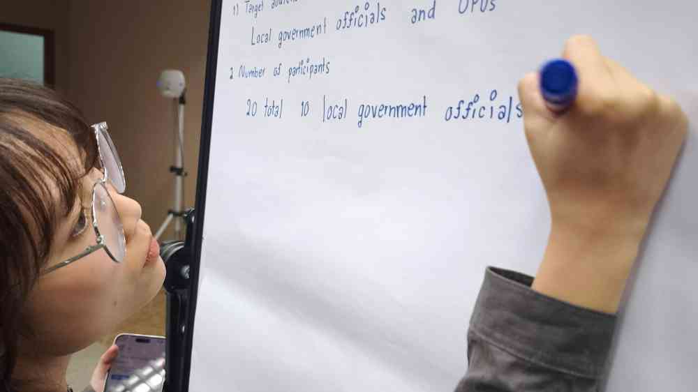 Participant writing on flipchart