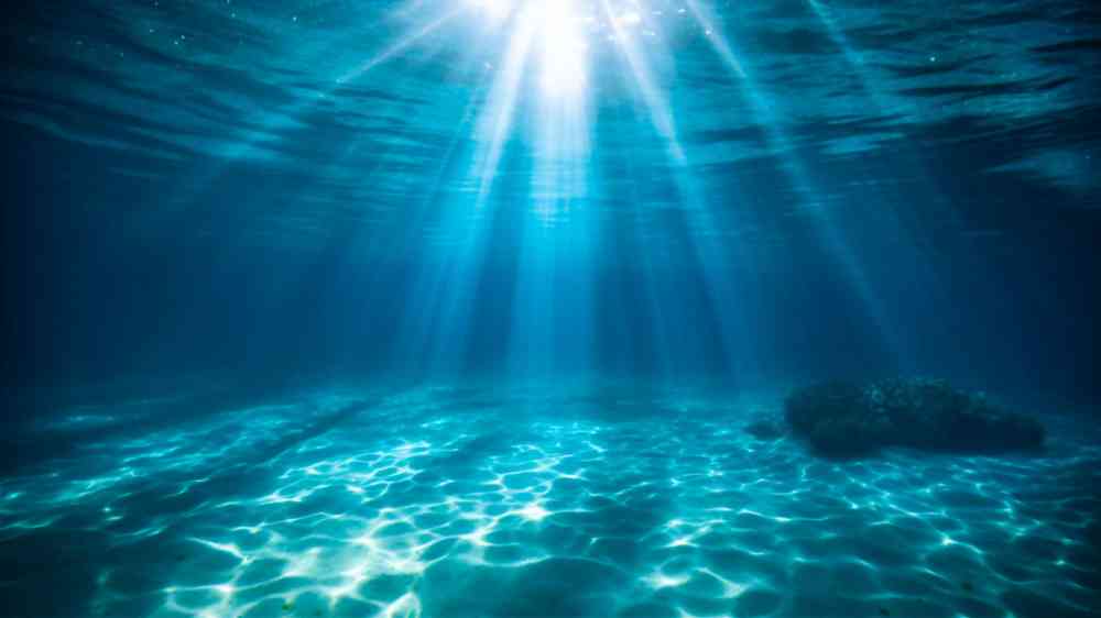 Ocean blue underwater with sunrays