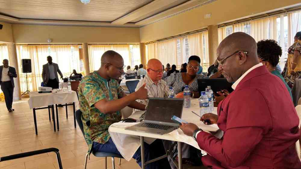 Participants attend the risk knowledge workshop in Burundi, held in February 2026. The focus of this photo is on a table of participants who are engaged in conversation