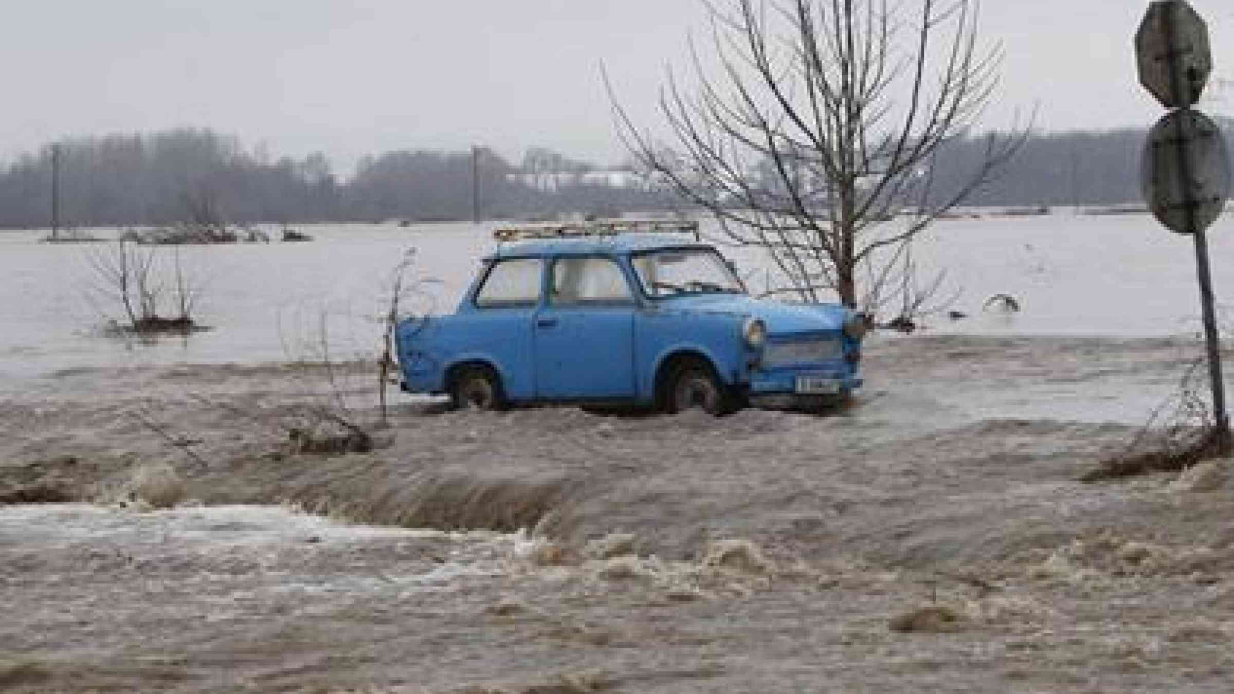 An abandoned car left in a flooded field following the failure of a dam in Bulgaria. (Photo: Bulfoto, AFP/Getty Images)