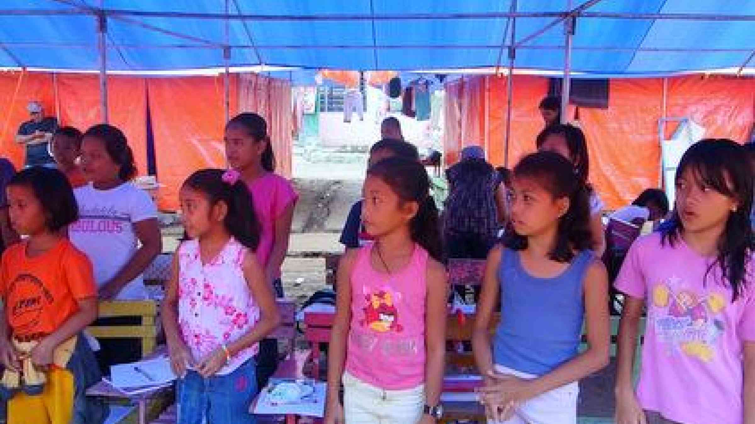 <b>Trying to get back to normal: </b>These schoolgirls are making the best of their makeshift classrooms.