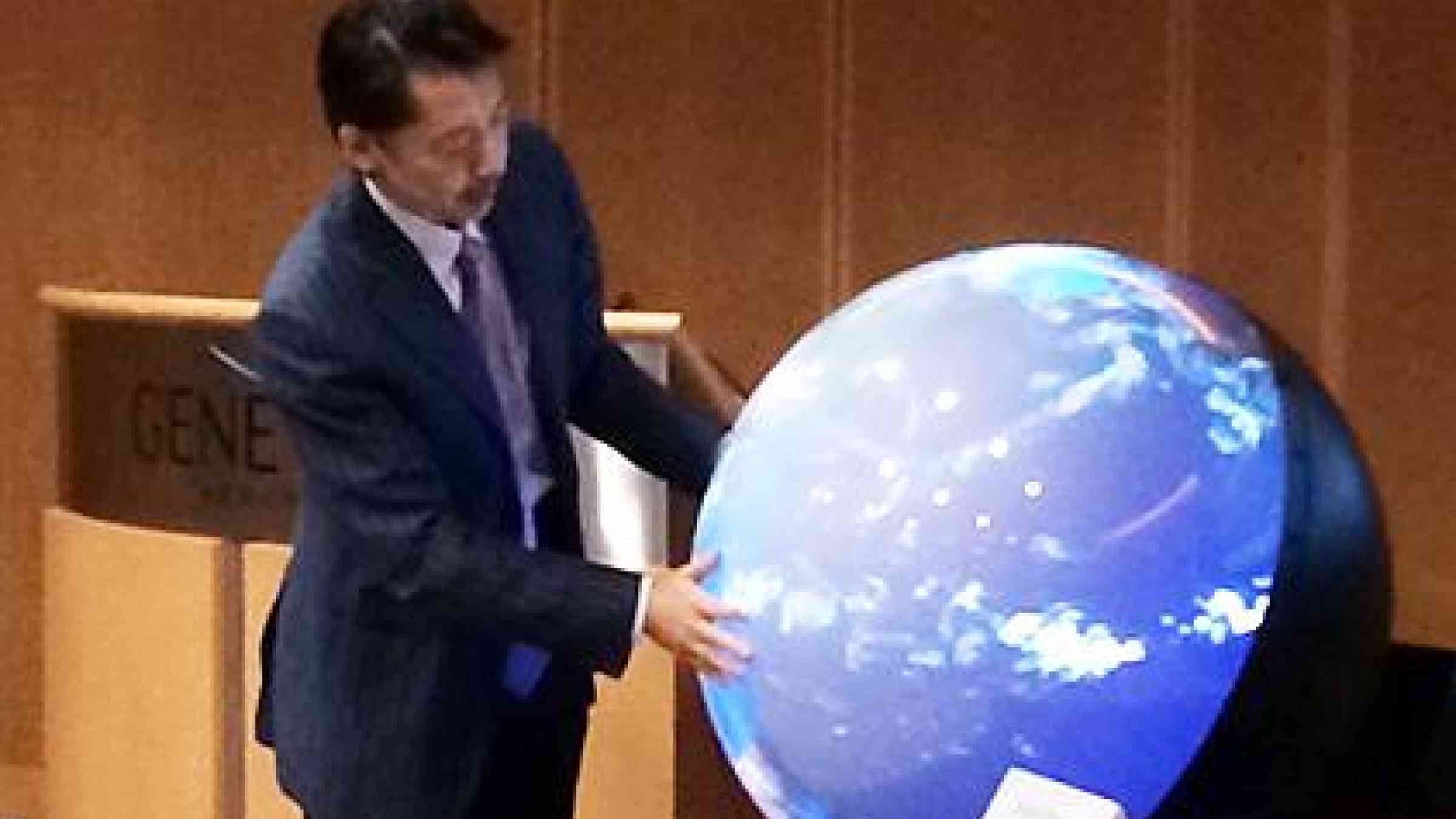 Prof. Shinichi Takemura demonstrating the use of Tangible Earth at Geneva Airport. (Photo: UN Geneva)