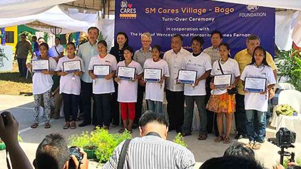 Yesterday's official hand-over ceremony of SM  Cares houses to survivors of Typhoon Haiyan/ Yolanda in the Philippines. Included in the photo are Hans Sy, SM Prime Holdings President,  Margareta Wahlstrom, UNISDR head, and Hilario Davide III, Governor of Cebu. (Photo: UNISDR)