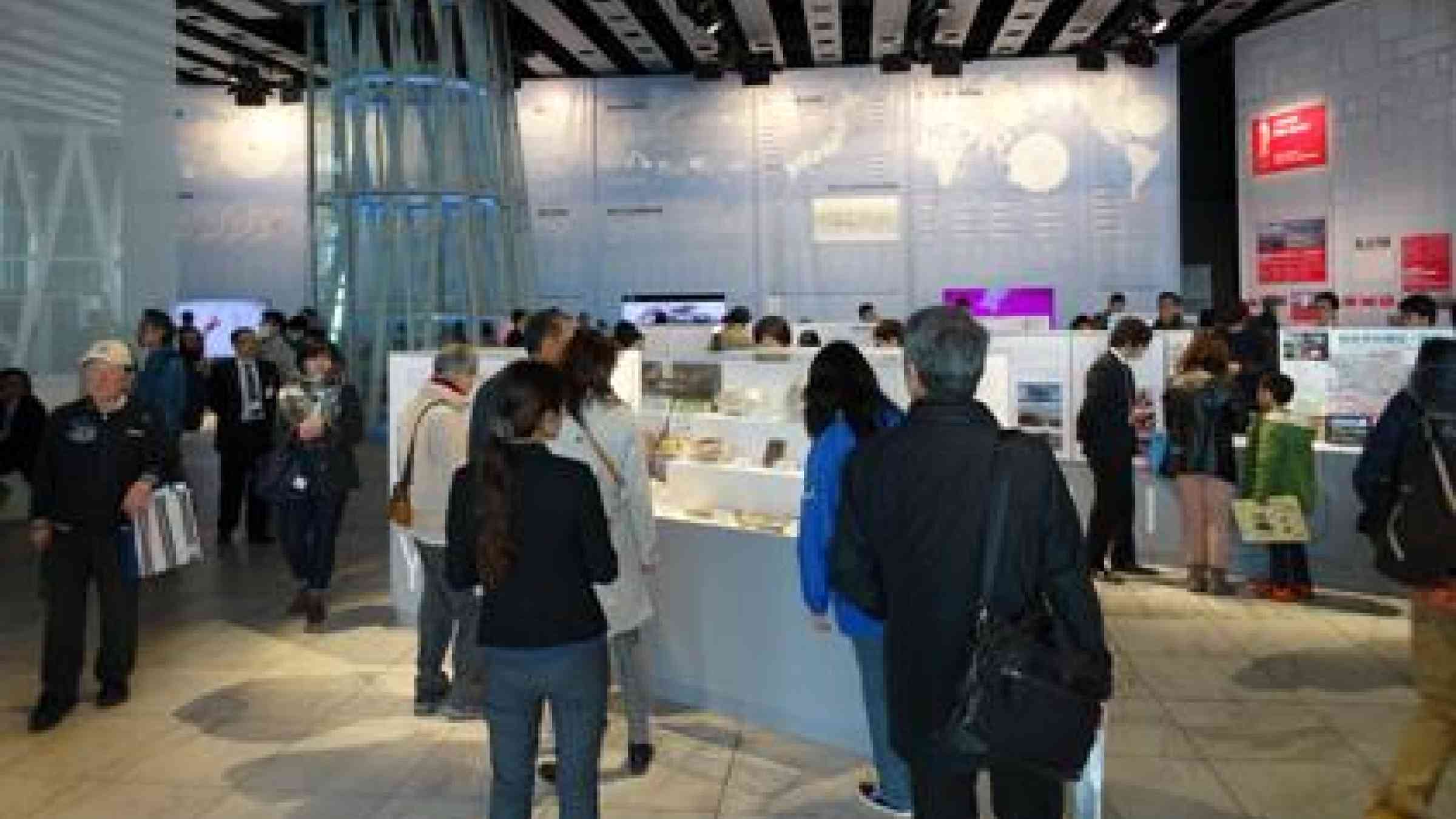 Visitors to the Public Forum of the WCDRR look at a display of personal items (centre) found in the rubble after the Great East Japan Earthquake and Tsunami. (Photo: UNISDR)