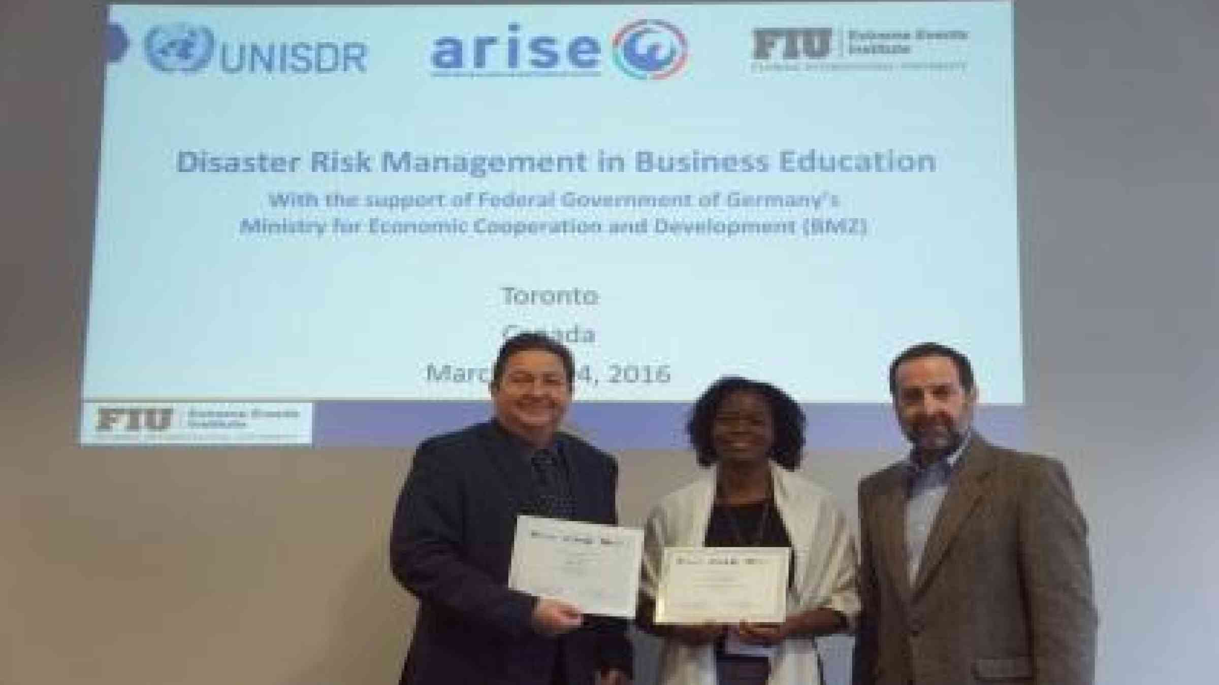 Ms. Indianna D. Minto-Coy (centre) from the Mona School of Business & Management, University of the West Indies, winner of the award for best disaster risk management new academic offering, is congratulated by Professor Juan Pablo Sarmiento of Florida International University (right) and Mr. Neil McFarlane of UNISDR (left) (Photo: UNISDR)