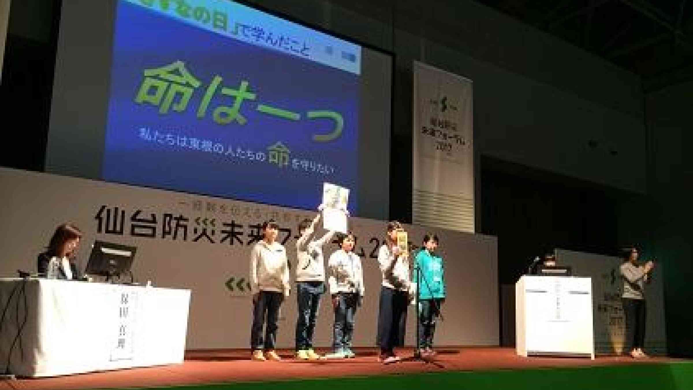 Caption: Children from Higashine elementary school show delegates the disaster risk information leaflet that they made for their community (Photo:UNISDR)