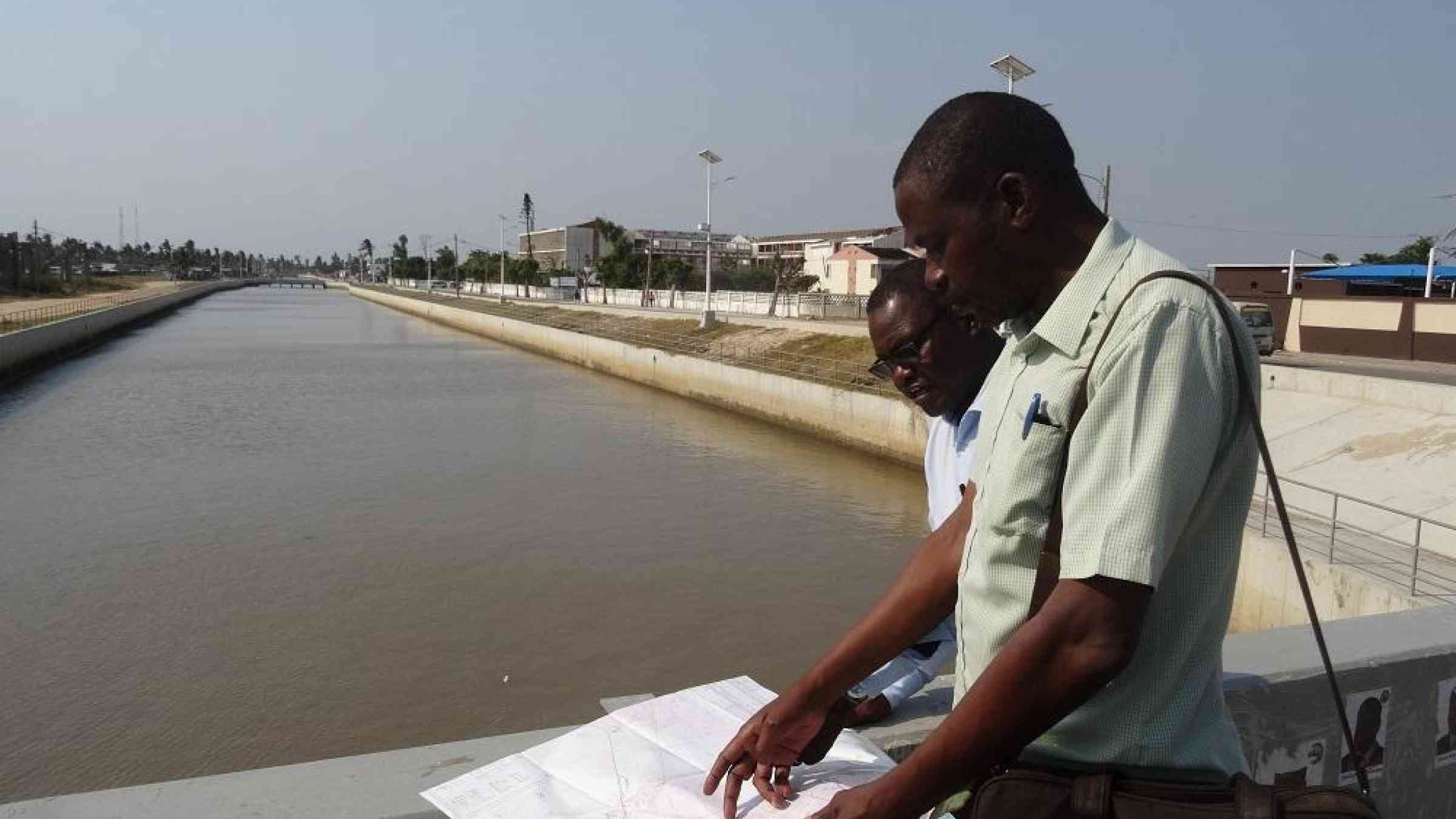 (From left) Jose Manuel Moisés, city councilor for institutional affairs and Beira city engineer, Augusto Manhoca, overlooking the canal which reduced the impact of the rains which hit Beira with Cyclone Idai in March, 2019