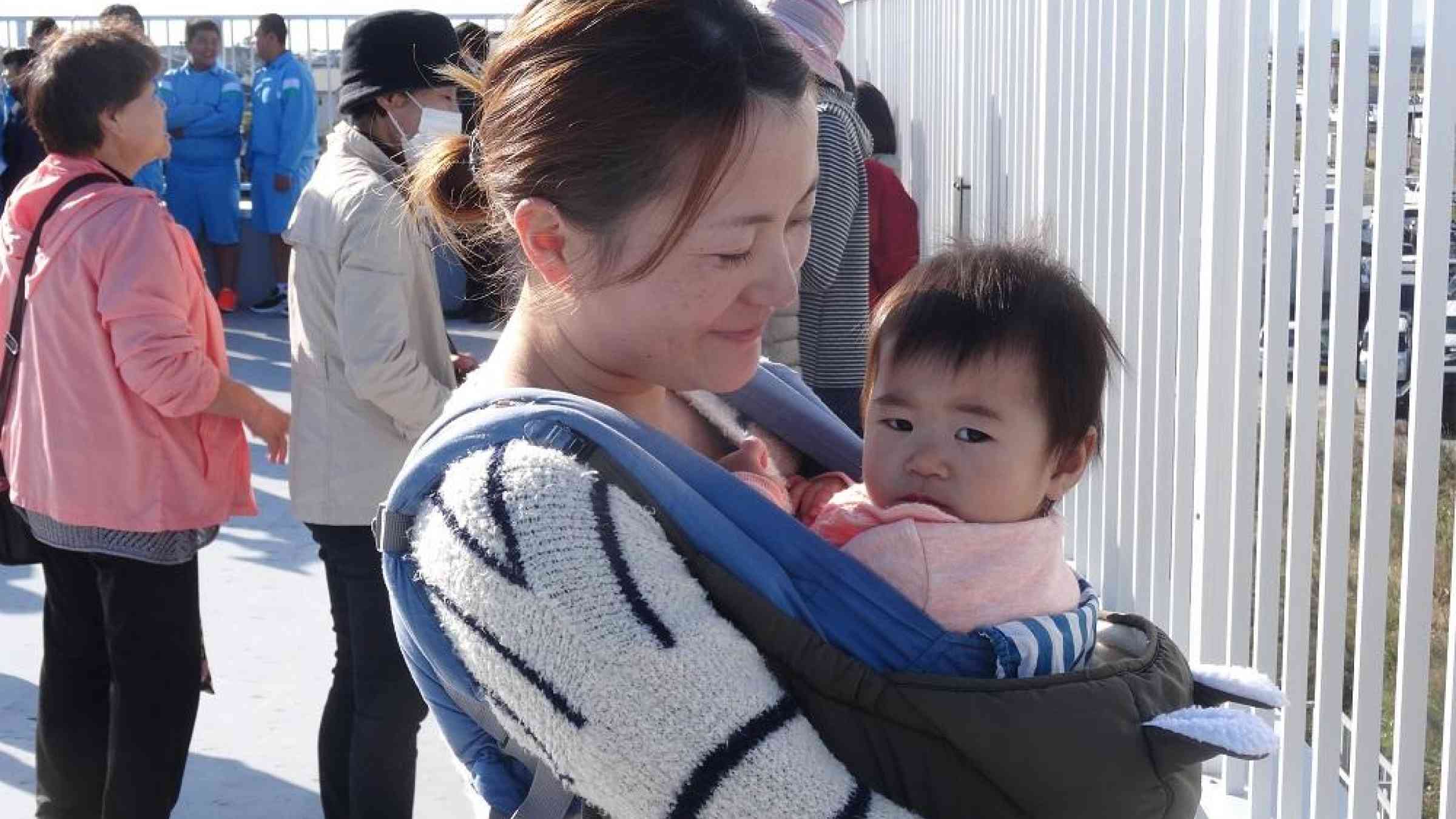 Mother and child safe on the top of a Sendai tsunami evacuation tower in today's evacuation exercise