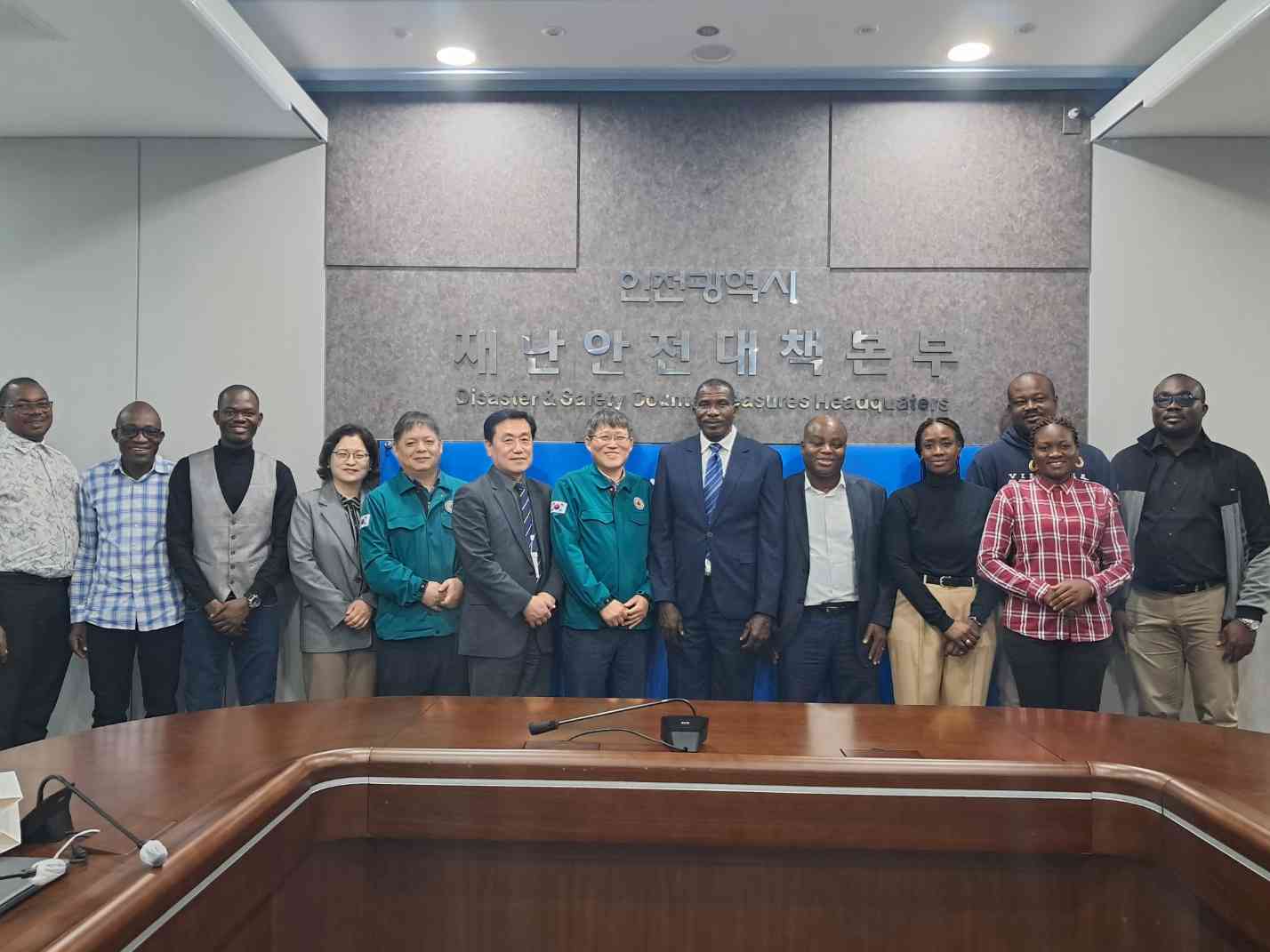 Workshop participants pose for a formal group photo at headquarters