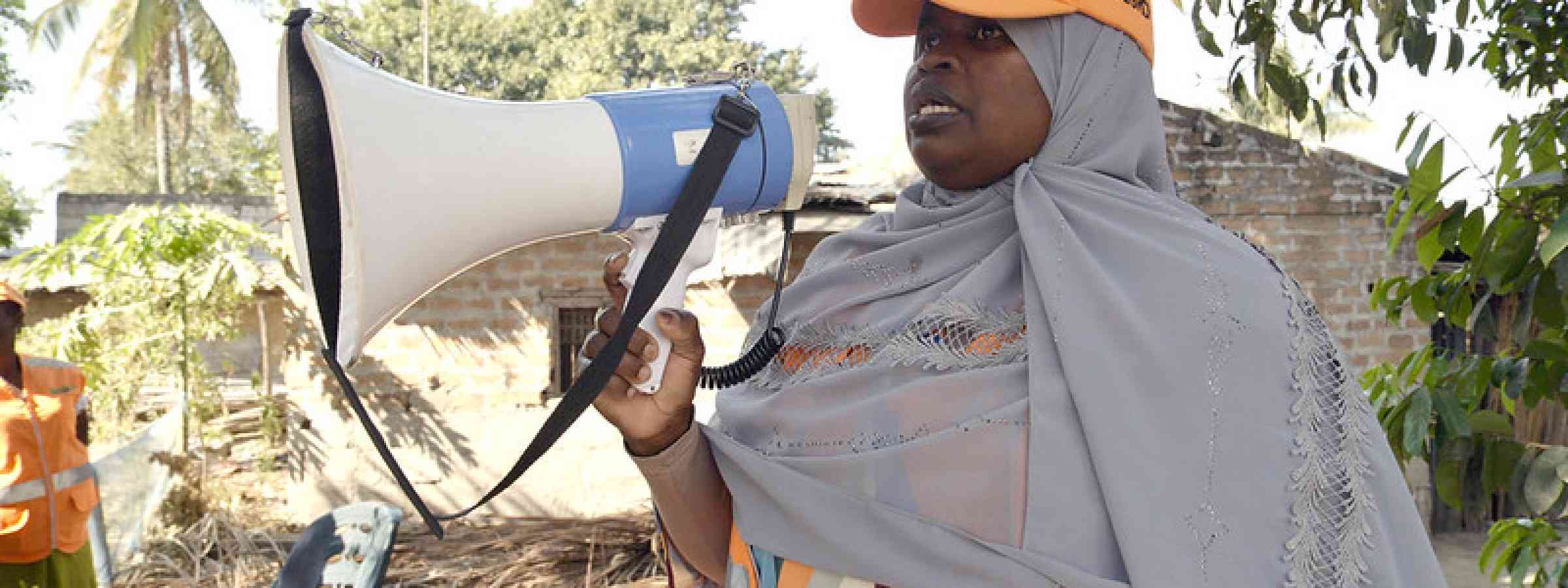 A local disaster risk reduction committee member in Mocuba District uses a megaphone to communicate early warning information during a simulation exercise