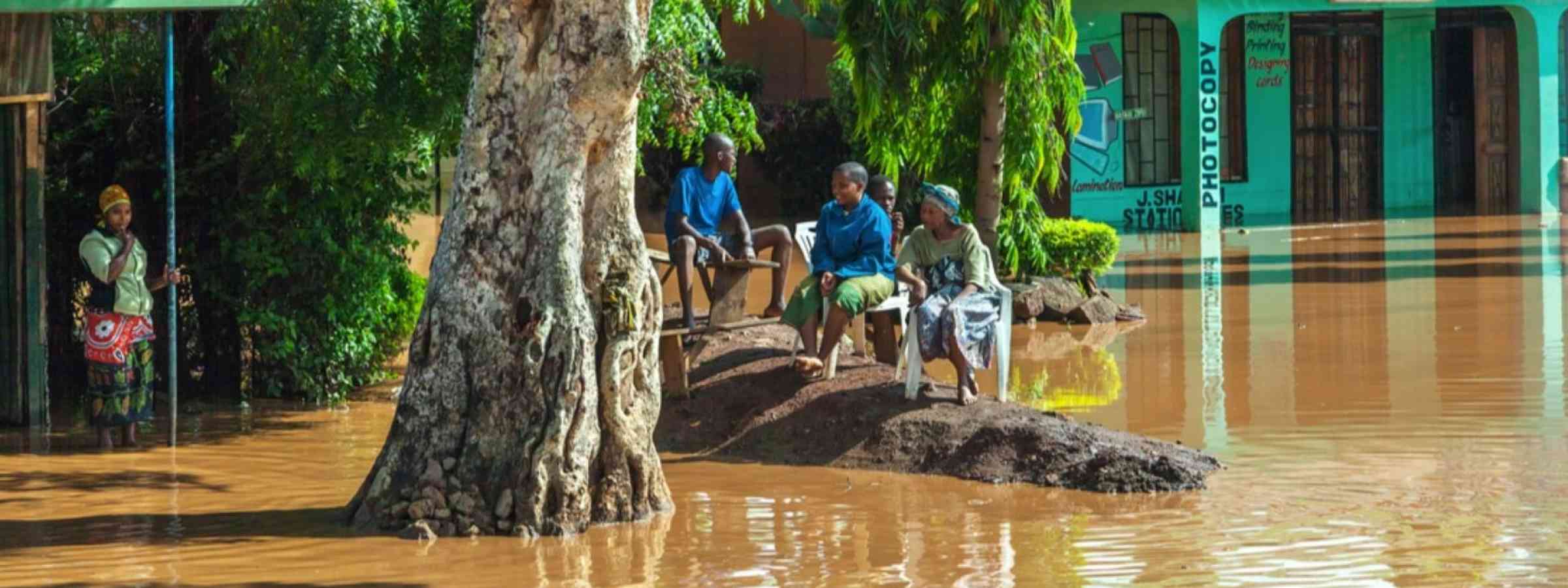 People sitting during flooding in Liberia