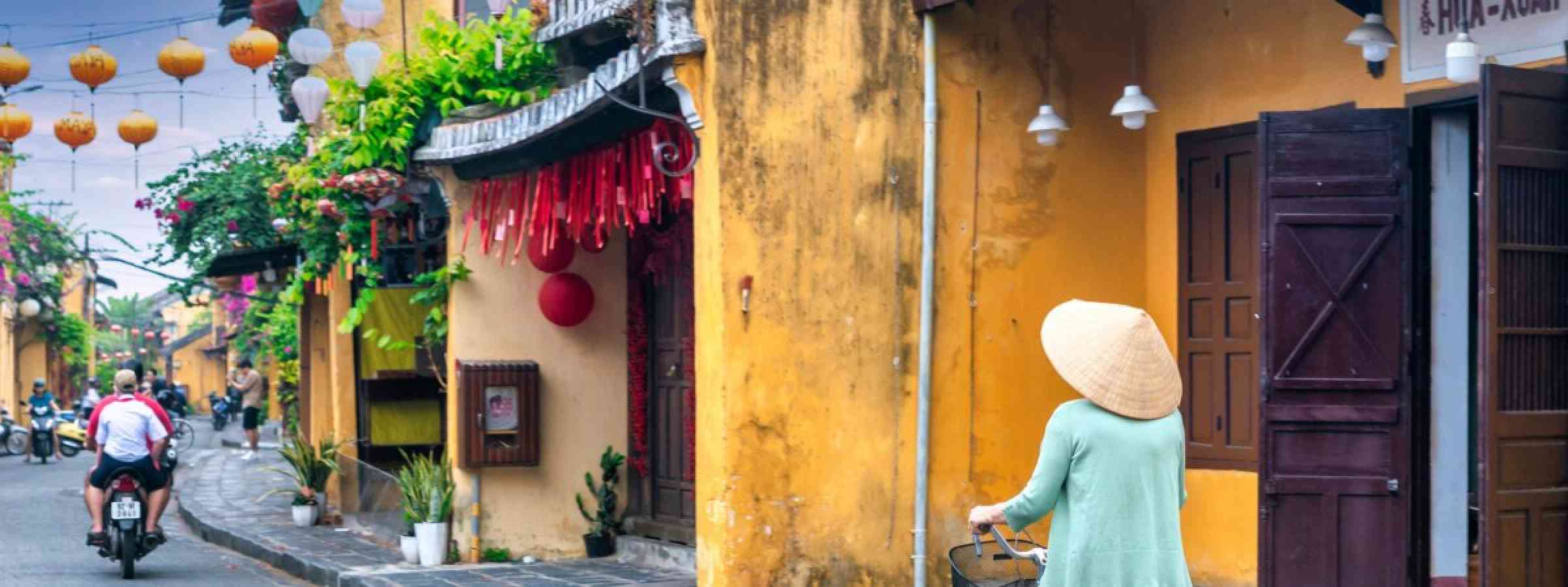 Hoi An, Vietnam - April 16th, 2024: Scenic morning of trafic, decorated silk lanterns, amazing traditional old yellow houses. The historic old town of Hoi An is UNESCO World Heritage Site since 1999.